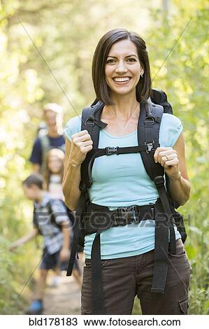 Stock Image - Caucasian family hiking on path. Fotosearch