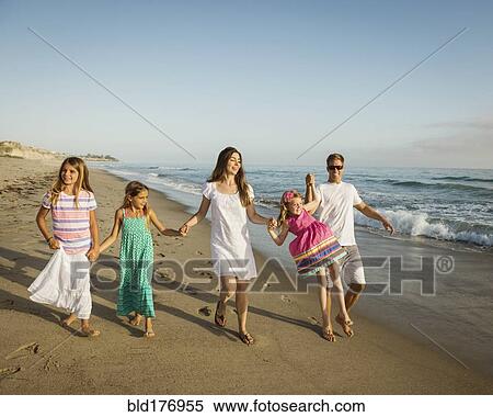 Caucasian family holding hands on beach View Large Photo Image Stock Photography - Caucasian family holding hands on beach. Fotosearch