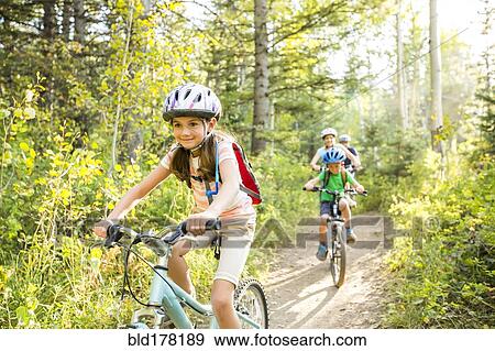 Caucasian family riding mountain bikes View Large Photo Image Stock Photo - Caucasian family riding mountain bikes. Fotosearch