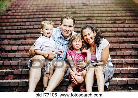 Caucasian family sitting on steps View Large Photo Image Stock Photograph - Caucasian family sitting on steps. Fotosearch