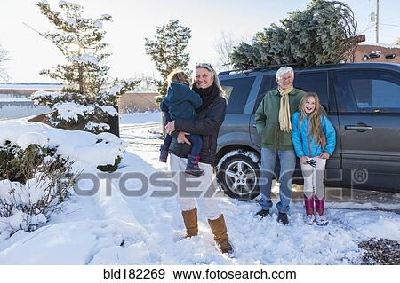 Caucasian family smiling in snow View Large Photo Image Stock Photo - Caucasian family smiling in snow. Fotosearch