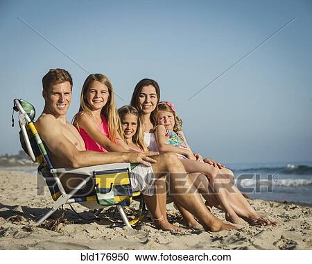 Caucasian family smiling on beach View Large Photo Image Stock Image - Caucasian family smiling on beach. Fotosearch