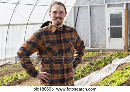 Caucasian farmer standing in greenhouse View Large Photo Image Stock Photography - Caucasian farmer standing in greenhouse. Fotosearch