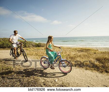 Caucasian father and daughter riding bicycles on beach View Large Photo Image Stock Photograph - Caucasian father and daughter riding bicycles on beach. Fotosearch