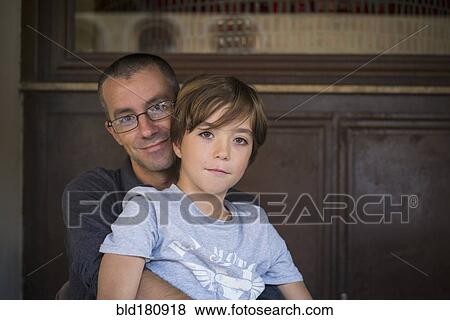 Stock Photo - Caucasian father and son hugging. Fotosearch