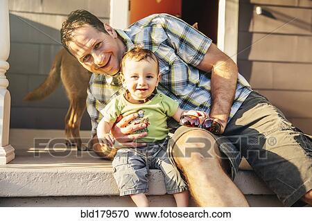 Caucasian father and son sitting on patio View Large Photo Image Stock Image - Caucasian father and son sitting on patio. Fotosearch
