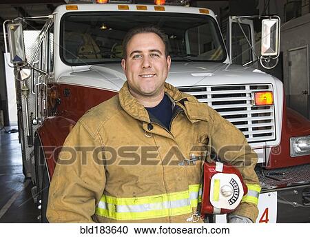 Caucasian firefighter smiling near fire truck View Large Photo Image Stock Image - Caucasian firefighter smiling near fire truck. Fotosearch
