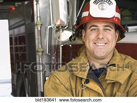 Caucasian firefighter smiling near fire truck View Large Photo Image Stock Image - Caucasian firefighter smiling near fire truck. Fotosearch