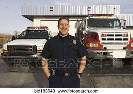 Caucasian firefighter smiling near fire trucks View Large Photo Image Stock Image - Caucasian firefighter smiling near fire trucks. Fotosearch