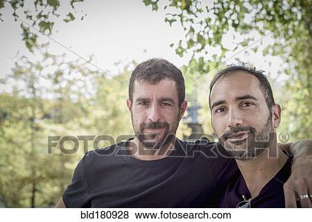 Caucasian gay couple hugging outdoors View Large Photo Image Stock Photo - Caucasian gay couple hugging outdoors. Fotosearch