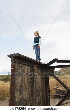 Caucasian girl climbing rusty structure outdoors View Large Photo Image Picture - Caucasian girl climbing rusty structure outdoors. Fotosearch