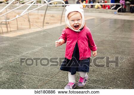 Stock Photograph - Caucasian girl laughing at park. Fotosearch