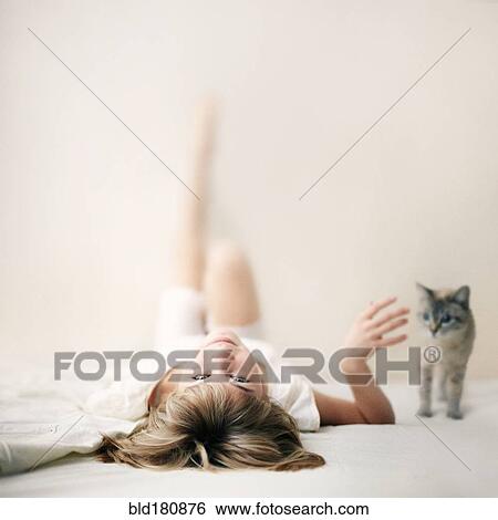 Stock Photograph - Caucasian girl laying on floor. Fotosearch
