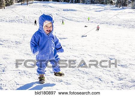 Stock Photo - Caucasian girl playing in snow. Fotosearch