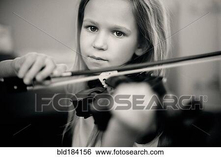 Stock Photograph - Caucasian girl playing violin. Fotosearch
