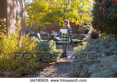 Caucasian girl reading in backyard View Large Photo Image Stock Photography - Caucasian girl reading in backyard. Fotosearch