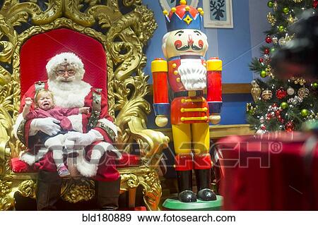 Caucasian girl sitting on lap of Santa and crying View Large Photo Image Stock Photo - Caucasian girl sitting on lap of Santa and crying. Fotosearch