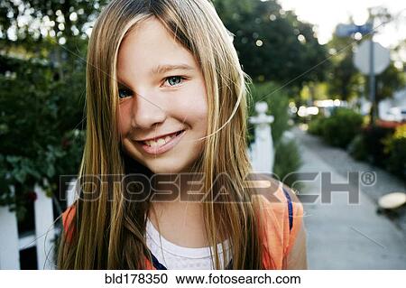 Caucasian girl smiling outdoors View Large Photo Image Stock Image - Caucasian girl smiling outdoors. Fotosearch