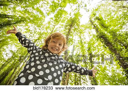Caucasian girl standing in forest View Large Photo Image Stock Image - Caucasian girl standing in forest. Fotosearch