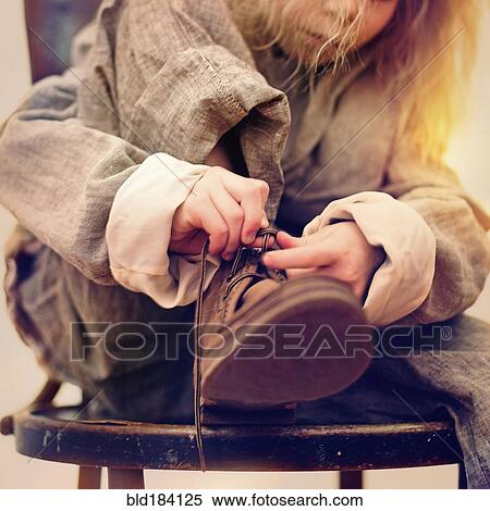 Caucasian girl tying her shoe View Large Photo Image Stock Photography - Caucasian girl tying her shoe. Fotosearch