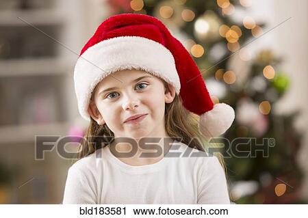 Caucasian girl wearing Santa hat View Large Photo Image Stock Image - Caucasian girl wearing Santa hat. Fotosearch