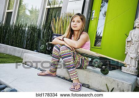 Caucasian girl with skateboard on front stoop View Large Photo Image Picture - Caucasian girl with skateboard on front stoop. Fotosearch