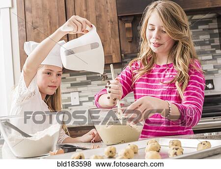 Caucasian girls baking in kitchen View Large Photo Image Stock Photo - Caucasian girls baking in kitchen. Fotosearch