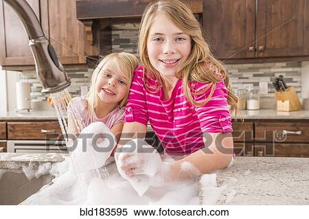 Caucasian girls washing hands in kitchen sink View Large Photo Image Stock Photography - Caucasian girls washing hands in kitchen sink. Fotosearch