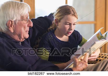 Stock Photo - Caucasian grandfather and granddaughter reading. Fotosearch