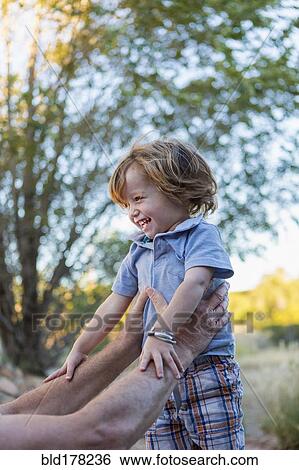 Caucasian grandfather holding grandson outdoors View Large Photo Image Stock Photograph - Caucasian grandfather holding grandson outdoors. Fotosearch