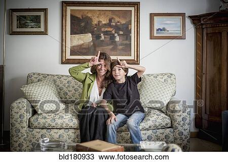 Stock Image - Caucasian grandmother and grandson gesturing loser. Fotosearch