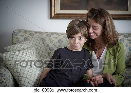 Caucasian grandmother and grandson sitting on sofa View Large Photo Image Stock Photography - Caucasian grandmother and grandson sitting on sofa. Fotosearch