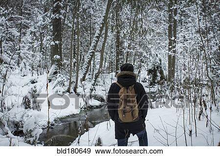 Caucasian hiker walking in snowy forest View Large Photo Image Stock Photo - Caucasian hiker walking in snowy forest. Fotosearch