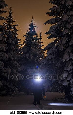Caucasian hiker wearing headlamp in snowy forest View Large Photo Image Stock Photograph - Caucasian hiker wearing headlamp in snowy forest. Fotosearch