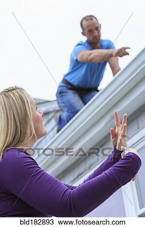 Caucasian homeowner signing to deaf roofer View Large Photo Image Stock Image - Caucasian homeowner signing to deaf roofer. Fotosearch