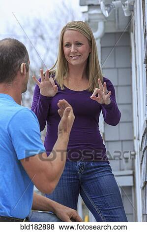 Caucasian homeowner signing to deaf repairman View Large Photo Image Stock Photo - Caucasian homeowner signing to deaf repairman. Fotosearch