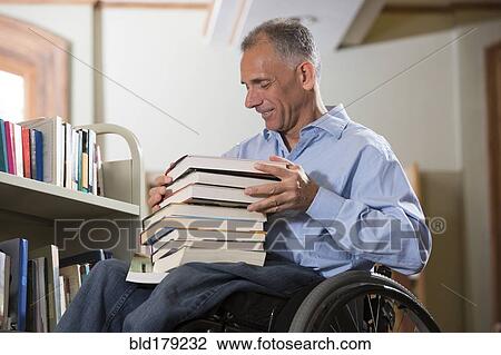 Caucasian man choosing book in library View Large Photo Image Stock Image - Caucasian man choosing book in library. Fotosearch