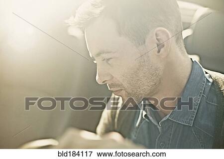Stock Photo - Caucasian man driving car. Fotosearch