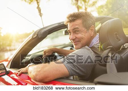 Caucasian man driving convertible View Large Photo Image Stock Photo - Caucasian man driving convertible. Fotosearch