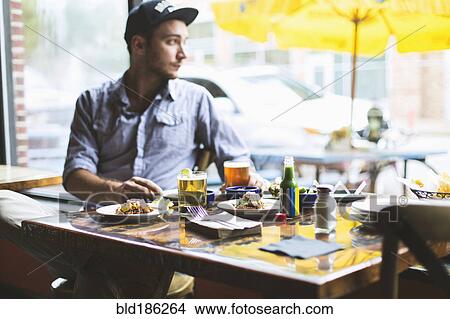 Caucasian man eating tacos in restaurant View Large Photo Image Picture - Caucasian man eating tacos in restaurant. Fotosearch