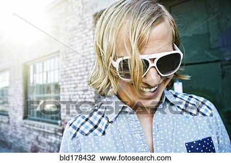 Stock Image - Caucasian man laughing outdoors. Fotosearch