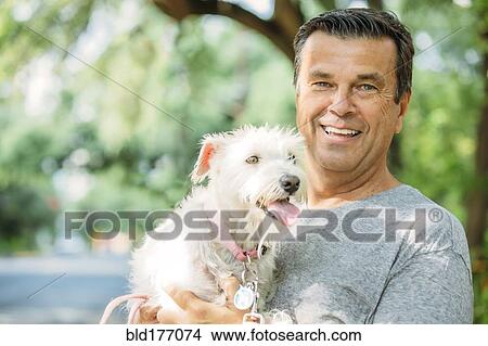 Caucasian man petting dog outdoors View Large Photo Image Picture - Caucasian man petting dog outdoors. Fotosearch