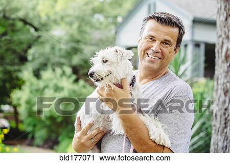 Caucasian man petting dog outdoors View Large Photo Image Stock Image - Caucasian man petting dog outdoors. Fotosearch