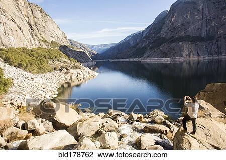 "Caucasian man photographing lake in Yosemite National Park, California, United States" View Large Photo Image Stock Image - "Caucasian man photographing lake in Yosemite National Park, California, United States". Fotosearch