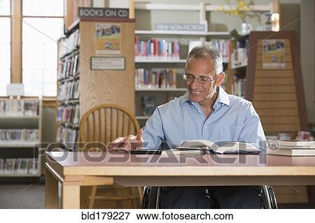 Caucasian man reading in library View Large Photo Image Stock Photo - Caucasian man reading in library. Fotosearch