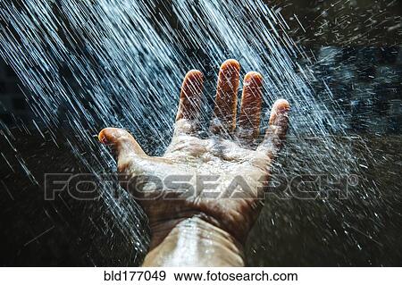 Stock Photo - Caucasian man rinsing hand under water. Fotosearch
