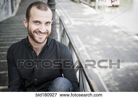 Caucasian man sitting on outdoor staircase View Large Photo Image Stock Photo - Caucasian man sitting on outdoor staircase. Fotosearch