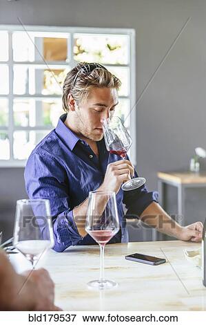 Caucasian man smelling wine in restaurant View Large Photo Image Stock Photo - Caucasian man smelling wine in restaurant. Fotosearch
