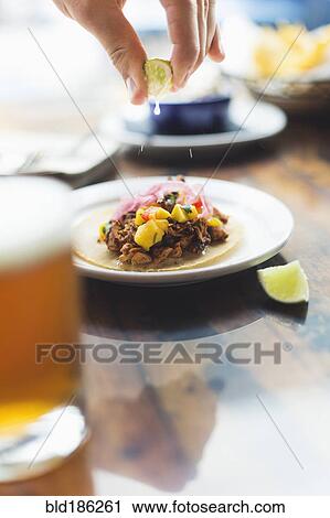 Caucasian man squeezing lime on taco View Large Photo Image Stock Image - Caucasian man squeezing lime on taco. Fotosearch