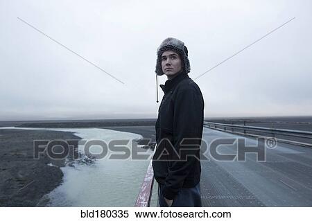 Caucasian man standing on remote road View Large Photo Image Stock Photography - Caucasian man standing on remote road. Fotosearch